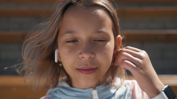 Portrait of Kid Outdoor. Portrait of Cute Child Outdoor with Headphones, Cute Girl Smiling