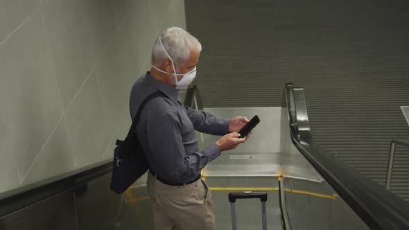 Caucasian man out and about in a metro station wearing on a face mask against coronavirus