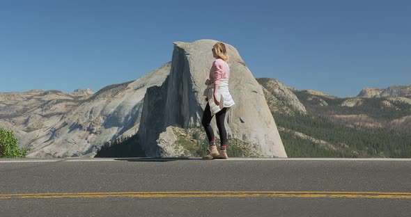 Young Attractive Girl Walking Outdoors on Background of Mountain Landscape, USA