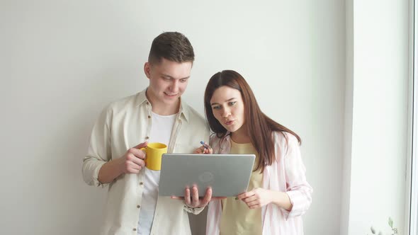 Young Good Looking Programmer Fixing Woman's Computer