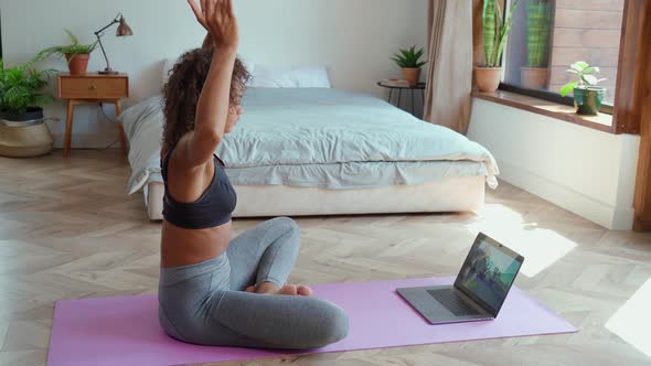 Young Healthy African American Girl Watching Online Yoga Class Sitting on Mat