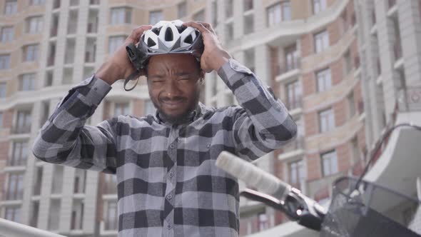 Portrait Confidient Handsome African American Man Standing with a Bicycle in Front of High Building