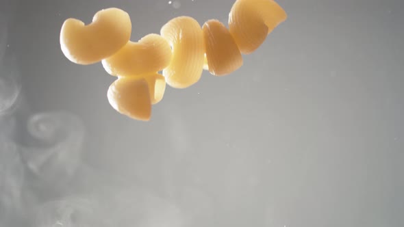 Camera follows cooking elbow macaroni pasta in tomato sauce. Slow Motion. alt