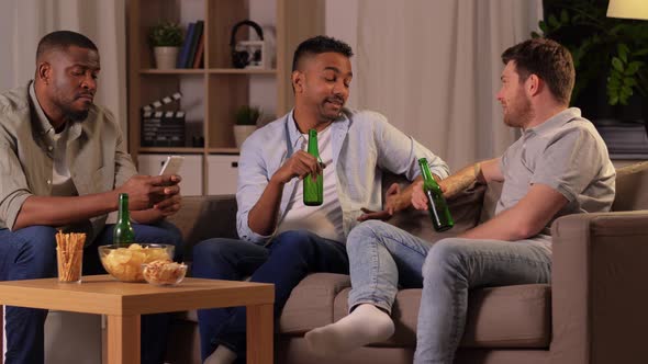 Male Friends Drinking Beer and Talking at Home