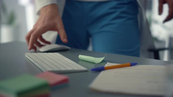 Doctor Sitting Desktop Using Computer in Hospital Closeup