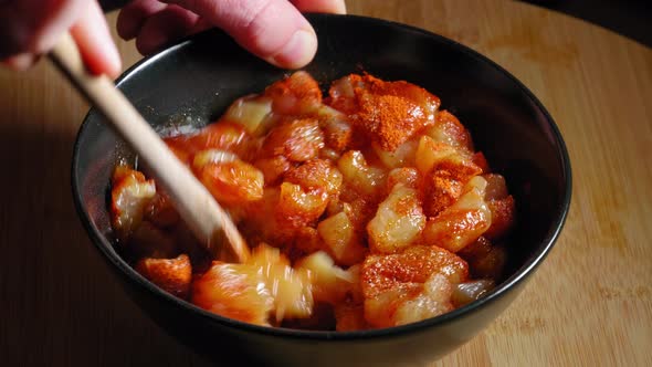 Mixing Fresh Uncooked Chicken Meat In A Bowl With Seasonings. close up