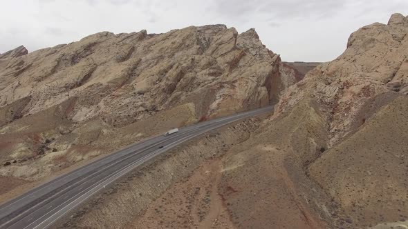 Rising aerial view of I-70 at the edge of the San Rafael Swell