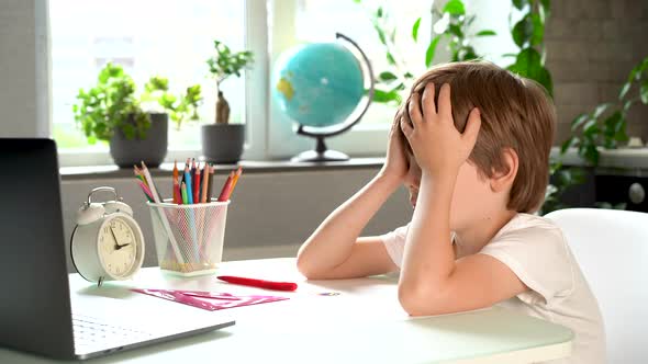 Little Boy Elementary School Student Falls Asleep at the Table Fatigue and Overwork of Firstgrader