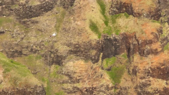 Tracking Shot of Helicopter Tourists Flying in Red Green Volcano Canyon Kauai