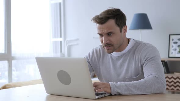 Upset Angry Adult Man Yelling While Working on Laptop