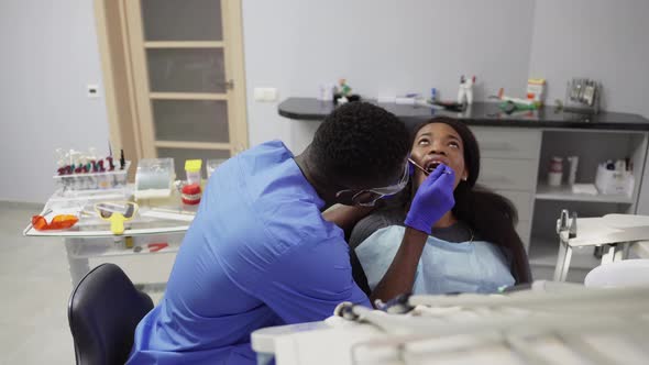 African Female Patient Getting Dental Treatment in Dental Clinic