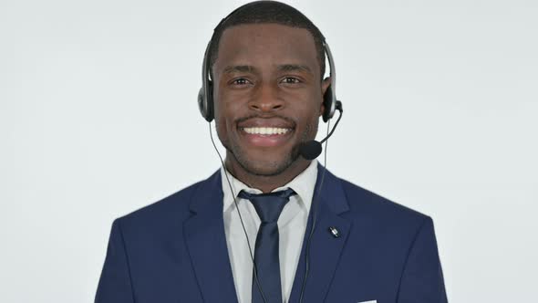 Smiling African Businessman with Headset for Call Center, White Background