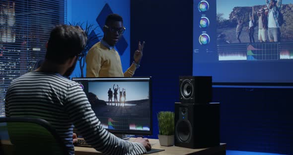 Young Man Editing Travelling Video Inside a Room