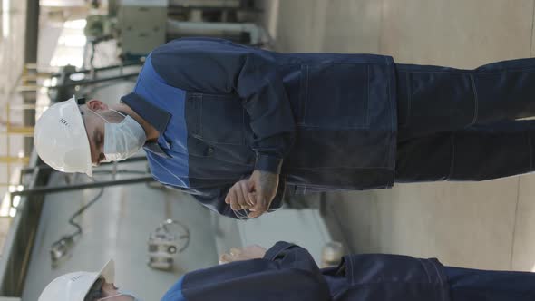  Supervisor Putting Sanitizer on Hands of Plant Workers