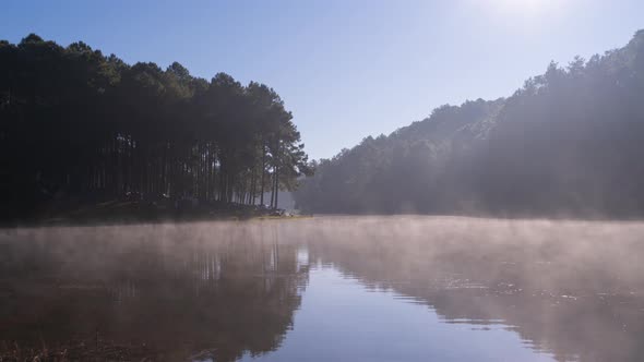 Time lapse of fog or mist on lake with forest trees in Pang Ung reservoir, Mae Hong Son, Thailand.