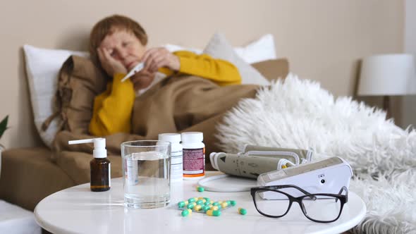 Sick Senior Woman Lying In Bed After Taking Medication At Home