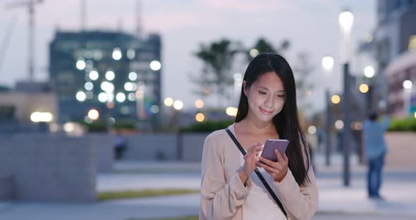 Woman Use of Mobile Phone in City at Night