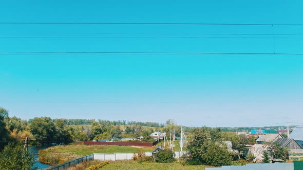 A Landscape of a Village and a Blue Sky - Shooting From the Train