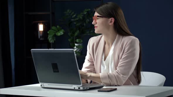 Beautiful Business Woman Distracted From Working on a Laptop