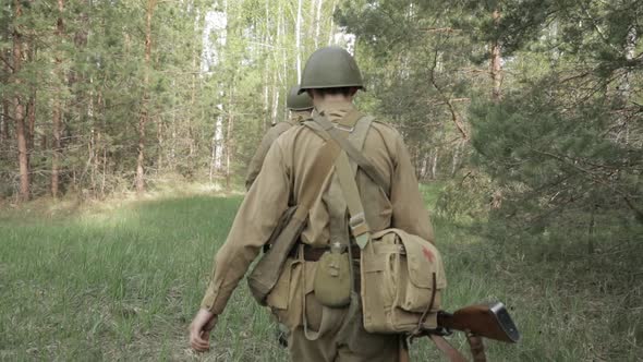 Russian Soviet Infantry Red Army Soldiers Of World War II Marching Walking Along Forest Road In