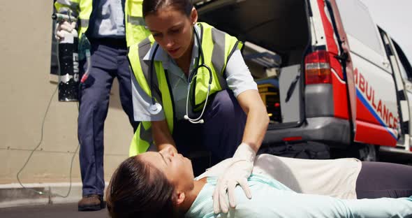 ambulance team treating a woman