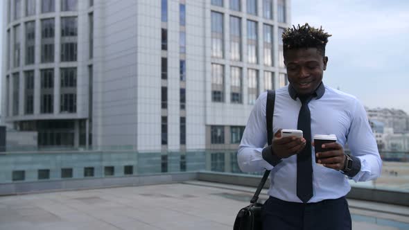 Businessman Drinking Coffee and Checking Phone