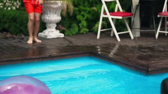 Live Camera Follows Cheerful Children Jumping in Swimming Pool in Slow Motion Splashing Blue Water