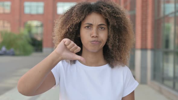 African Woman Showing Thumbs Down Gesture Outdoor