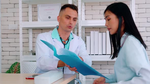 Doctor in Professional Uniform Examining Patient at Hospital