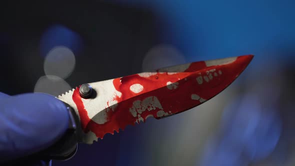 Forensic Examination of Knife with Blood, Conclusive Evidence, Hand Closeup