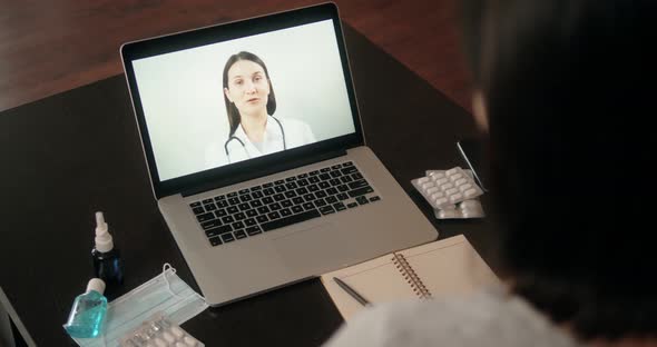 Back View of Man Making Video Call with Doctor While Staying at Home