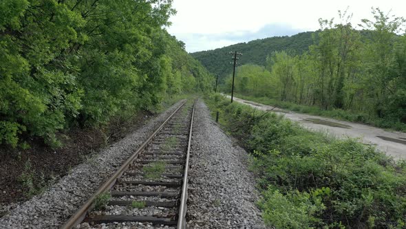 Old rural road  and railway track  in the valley 4K aerial video