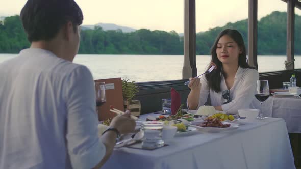 Asian Couple Happy Eating Food On Boat With A Nice View