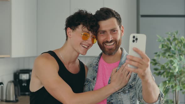 Lgbt Gays Smiling Couple Using the Smartphone for Video Call to Tell Good News to Their Relatives or