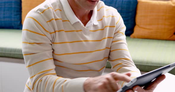 Male teacher using digital tablet