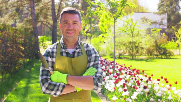 Happy Man in Apron with Scoop at Summer Garden