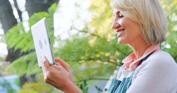 Mature woman using digital tablet