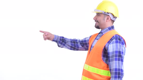 Profile View of Happy Bearded Persian Man Construction Worker Pointing Finger