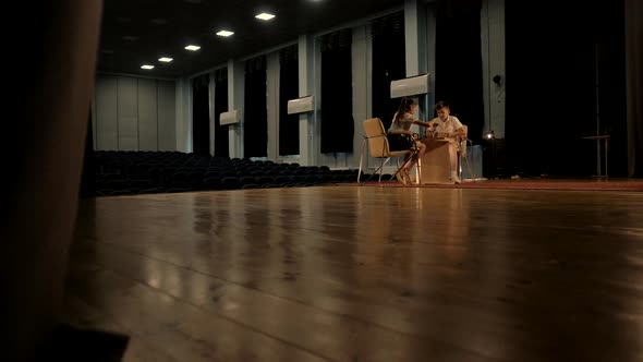 Two children, a preschool boy and a preschool girl, focus on a chess game during practice