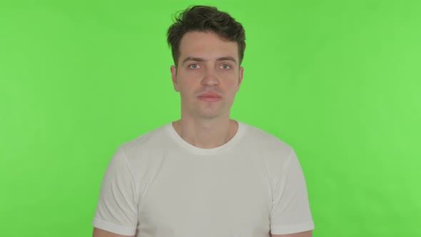 Disappointed Young Man Reacting Loss on Green Background