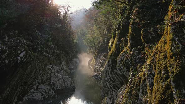 Flying Over a River Through a Narrow Canyon with White Rocks Sochi