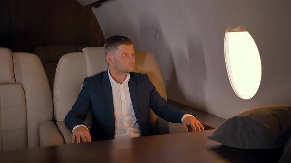 Portrait of Businessman Sitting in Business Jet Armchair