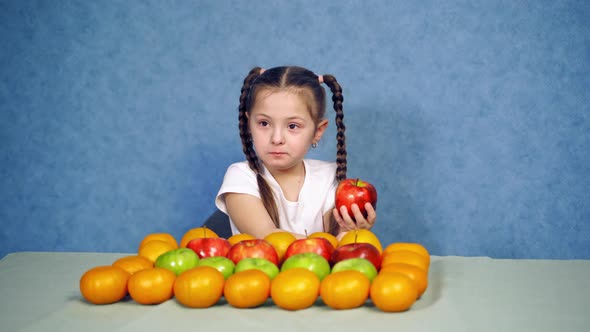 Child eating healthy food. Beautiful little girl with vegetables on a white background