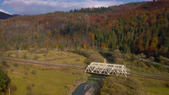 View From the Height on the Autumn Mountain Landscape - Yellow Forest, River, Railway Bridge and