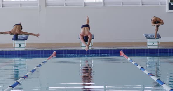 Swimmers diving into the pool