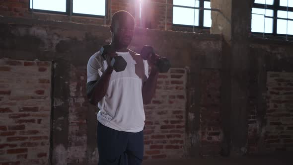 Workout, Sport man doing arm exercise with dumbbell at gym