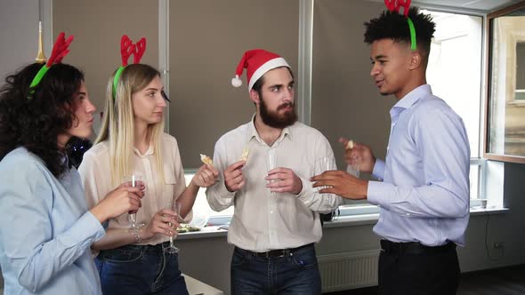 Young Attractive African Man Telling His Story During Corporate Christmas Party in the Office