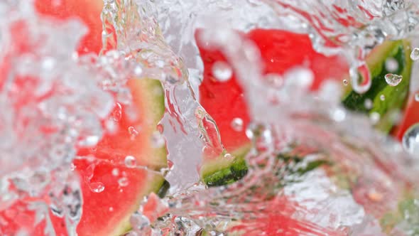 Super Slow Motion Shot of Melon Slices Falling Into Water Whirl at 1000 Fps