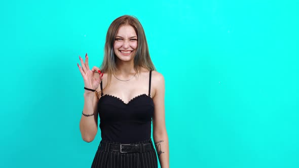 Woman Showing Ok Sign and Smiling Fulfilled at the Camera. Charming Girl,