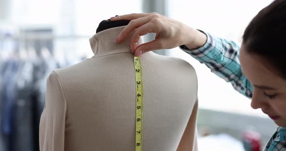 Tailor Works in Atelier and Takes Measurements Closeup